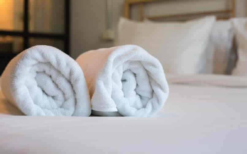 Towels on bed in accommodation